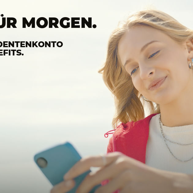 a woman smiling and holding a phone